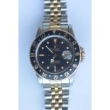 A gent's Rolex GMT Master in steel and gold with black dial and bezel. Est. £3500 - £4000.