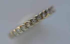 A small diamond full eternity ring in white gold. Ring size M. Est. £200 - £250.
