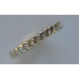 A small diamond full eternity ring in white gold. Ring size M. Est. £200 - £250.