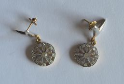 A pair of attractive white gold ear pendants of circular form with large central diamond. Est. £