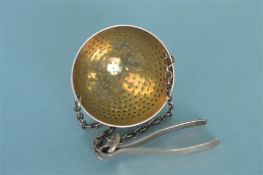 A George III tea strainer on suspension chain. London 1801. By Eley and Fearn. Est. £100 - £120