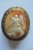 A large oval cameo of an angel in gold engraved frame. Est. £200 - £250.