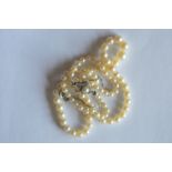 A good string of pearl beads with paste clasp. Est. £15 - £20.