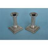 A pair of miniature column candlesticks with step base. Approx. 10 cms high. Birmingham 1900. By C&