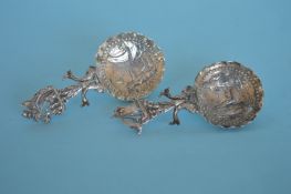 A pair of dutch caddy spoons with floral decoration. Est. £20 - £30