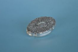 A small oval hinge top trinket box with scroll dec