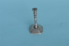 An unusual miniature Continental cast candlestick. Approx. 5 cms high. Est. £70 - £80.