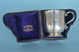 A boxed small Christening cup with gilt interior. London 1880. By R&S. Est. £150 - £200.