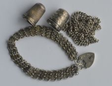 A silver gate bracelet together with thimbles and