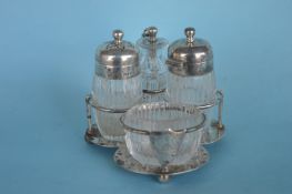 A small four bottle cruet with hinged cover and ba