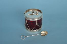 An unusual ruby glass mounted preserve dish in the form of a drum with spoon. Marked Sterling.
