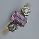 An 18 carat mounted pink sapphire and rose diamond three stone ring in two colour mount. Est. £250 -
