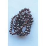 A faceted string of garnet beads. Est. £20 - £30.