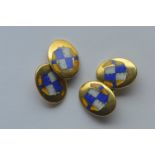 A pair of heavy 9 carat, enamel decorated, jockey cufflinks retailed by Hancocks. Approx. 14