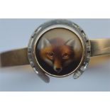 A good quality high carat bangle inset with oval porcelain miniature of a fox. surrounded by white