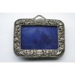 A rectangular photo frame, pierced with scrolls, f