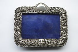 A rectangular photo frame, pierced with scrolls, f
