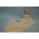 A Porcelain mounted doll with detachable body. Est
