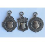 A group of three silver watch medallions. Est. £20 - £30.