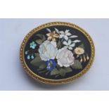 A good quality oval pietra dura brooch in the form of flowers in high carat frame. Est. £380 - £420.
