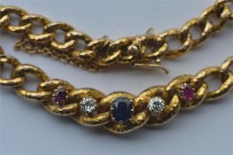 A 15 carat ruby, sapphire and diamond bracelet with concealed clasp. Est. £400 - £500.