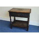 A good Oak carved side table with brass handle. Es