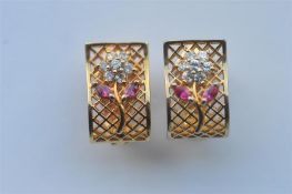 A pair of gold, ruby and diamond ear studs with hinged mount. Approx. 7 grams. Est. £70 - £80.