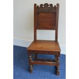 An Antique Oak hall chair having fielded panel to