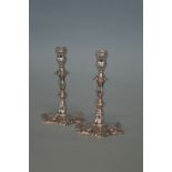 A pair of good cast tapering candlesticks with hex