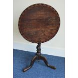 An Antique Oak tripod table, the top with decorati