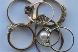 A heavy bundle of seven gold gem set rings. Approx. 15 grams. Est. £280 - £320.