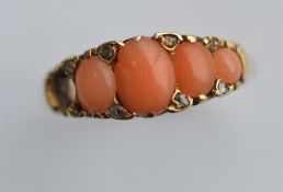 A 9 carat rose gold coral and rose diamond ring. Approx. 2.6 grams. Est. £20 - £30.