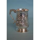 An early floral embossed pint tankard on sweeping