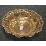 A circular sterling fruit dish heavily decorated with leaves and scrolls. Approx. 490 grams. Est. £