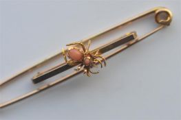 A 9 carat clip brooch together with a heavy 9 carat coral set spider brooch. Approx. 9.5 grams. Est.