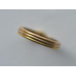 CARTIER: A good heavy wedding band of three colour gold. Numbered B33642. Finger size T. Approx. 6