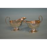 A pair of good pedestal sauce boats with reeded ri