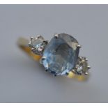 An 18 carat diamond and blue stone ring in claw mount. Est. £80 - £100.