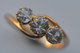 A good 18 carat mounted three stone ring in claw mount. Est. £150 - £200.