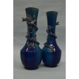A pair of good blue ground vases decorated with dr