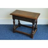 A reproduction Oak joint stool with carved frieze,