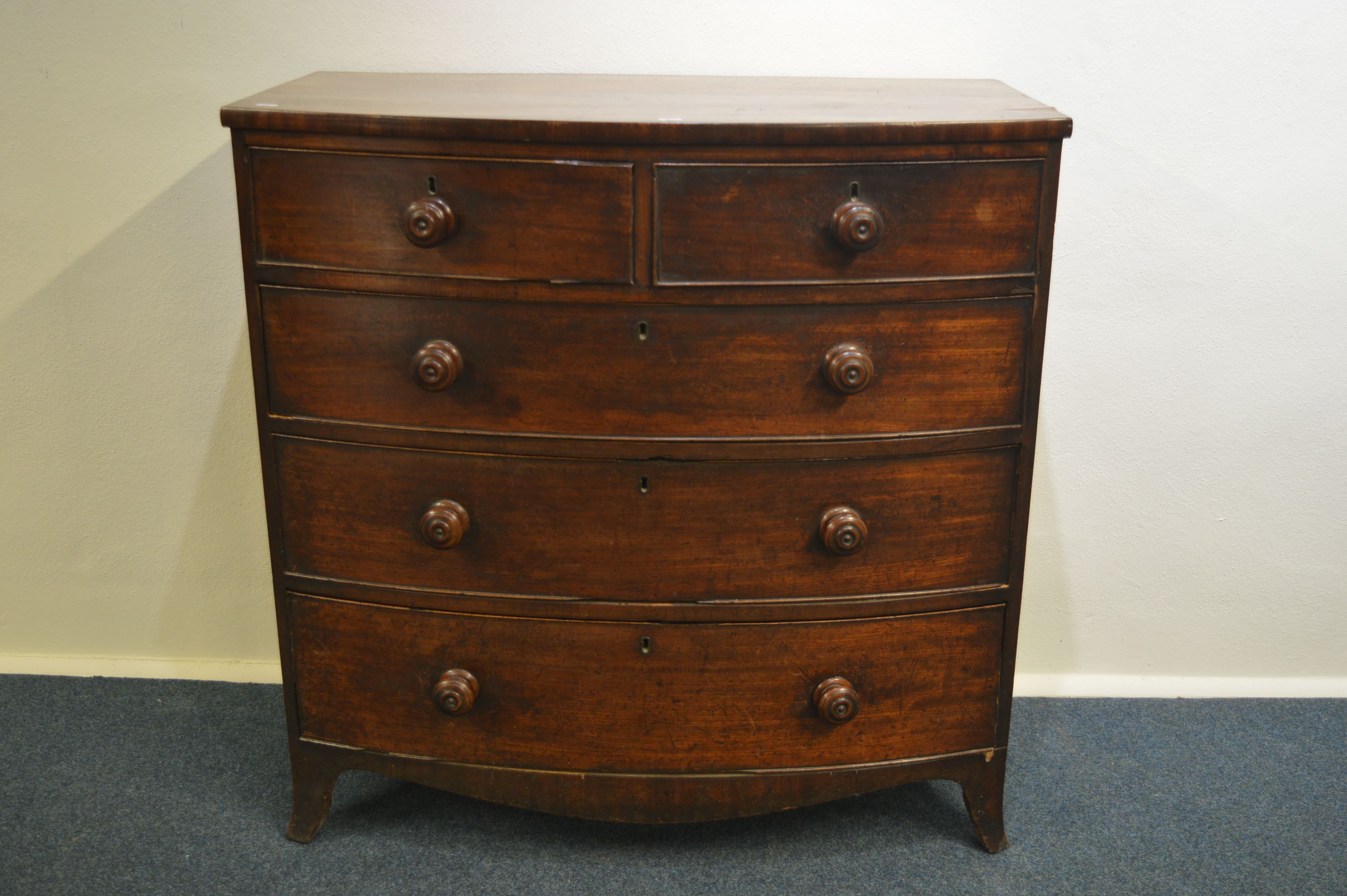 A Georgian bow front chest of five drawers on brac