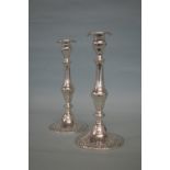 A pair of tall stirling candlesticks decorated wit