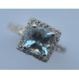 A heavy diamond and aquamarine cluster ring in 18 carat white gold. Est. £280 - £320.