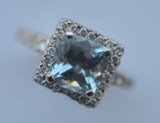 A heavy diamond and aquamarine cluster ring in 18 carat white gold. Est. £280 - £320.