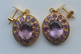 A pair of amethyst and gold drop earrings with loop tops. Approx. 12.7 grams. Est. £90 - £100.