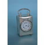 An attractive silver carriage clock with white ena