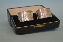 An attractive pair of silver and gold overlay napk