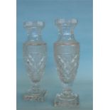 A large pair of decorative glass vases on square p