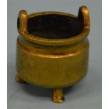 A small bronze brush pot on three sweeping feet ma